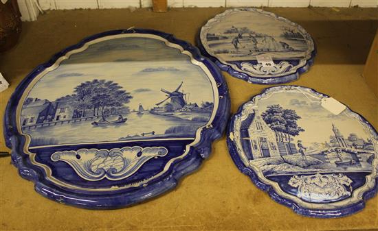 Dutch shaped oval plaque with river scene & a pair of similar Summer & Winter plaques (one a.f)